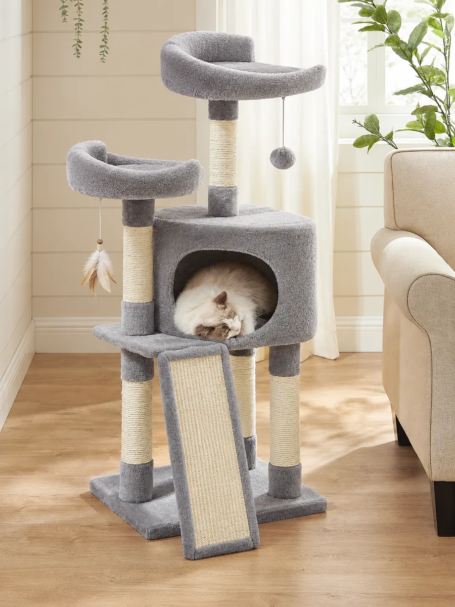 Light-grey multi-level cat tree in a living room, cat asleep in the house